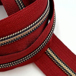 Reißverschluss Meterware mit 6,5 mm Antikmessing metallic Spiralraupe in weinrot mit marineblauer Naht.